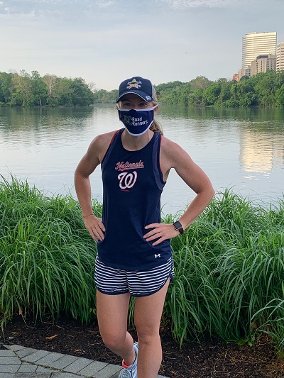 Aoife Cullen standing at the Georgetown Waterfront wearing a Washington Nationals jersey and a DC Road Runners COVID mask